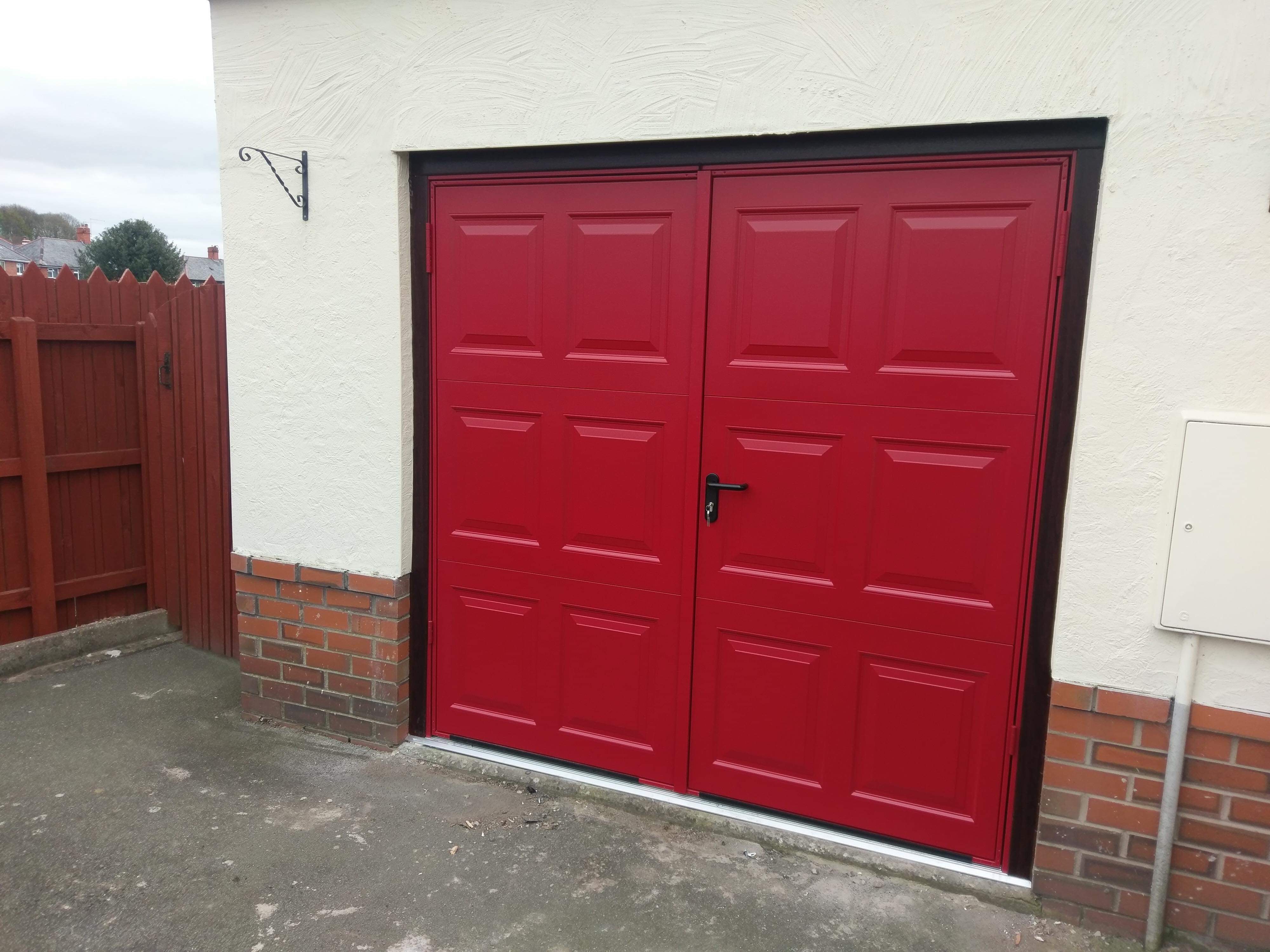 Georgian steel side hinged garage door in a red RAL colour
